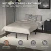 A metal bed frame with a mattress and pillows in a bedroom setting. Podgląd zdjęcia produktu