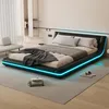 A modern bedroom with a black platform bed featuring blue LED lighting. Produktbild-Vorschau