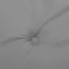 A close-up view of a tufted gray cushion or mattress. Produktbild-Vorschau