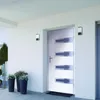 A modern white front door with silver accents, flanked by two wall-mounted outdoor lights and three potted plants. Náhľad obrázku produktu