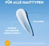 A swatch of white cream on a light blue background, with text annotations. Produktbild-Vorschau