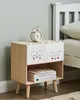 A child's bedside table with animal-themed drawers next to a bed. Náhled obrázku produktu