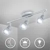 A silver-colored ceiling spotlight with three adjustable heads is mounted on a white ceiling. Produktbild-Vorschau