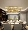 A dining room with a table set for a meal, illuminated by a crystal chandelier. Podgląd zdjęcia produktu