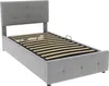 A grey upholstered bed frame with a slatted base, shown from a slightly elevated side angle against a white background. Náhľad obrázku produktu