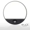 A circular LED outdoor wall light with a motion sensor is shown against a white and gray gradient background. The light is illuminated, and the brand name 'max KOMFORT' is visible in the lower right corner. Produktbild-Vorschau