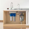A cutaway view of a kitchen sink cabinet showing a water filtration system installed. Produktbild-Vorschau