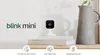 A Blink Mini camera is displayed on a shelf next to a vase and books, with feature icons below. Anteprima dell’immagine prodotto