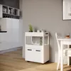 A white kitchen cart is shown in a modern kitchen setting, next to a dining table. Podgląd zdjęcia produktu