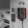 A collection of electronic devices and accessories arranged on a light gray surface. Produktbild-Vorschau