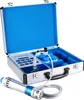 A shockwave therapy device in an open case, with a handheld applicator in the foreground. Produktbild-Vorschau