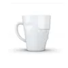A white ceramic mug with a grumpy face design. Náhľad obrázku produktu