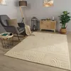 A living room scene with a rug, chair, lamp, and furniture.