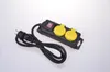 A black power strip with two yellow outlets and a red switch, lying on a white background. Produktbild-Vorschau