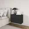 A modern bedroom scene with a bed and a black nightstand. Anteprima dell’immagine prodotto