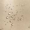 A close-up view of water droplets on a beige, textured fabric surface. Produktbild-Vorschau