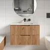 A modern bathroom vanity with a wooden front and a white countertop, set against white tiled walls. Náhled obrázku produktu