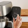 A hand is shown adjusting the dial on a kitchen appliance. Produktbild-Vorschau