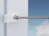 A close-up of a white curtain rod bracket with a silver rod extending from it, against a blue sky background. Produktbild-Vorschau