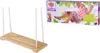 A product box for a wooden swing set, featuring a girl swinging and some wooden blocks. Produktbild-Vorschau