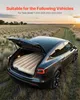 A car with its trunk open, showing an inflatable mattress inside, parked in a grassy field at sunset. Náhled obrázku produktu