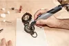 A hand is using a Dremel tool to work on an antique compass. Anteprima dell’immagine prodotto