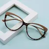 A pair of cat-eye glasses with a leopard print pattern on a light blue background, partially resting on a white frame. Náhled obrázku produktu
