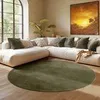 A modern living room with a sectional sofa, a large arched window, and a round rug. Náhled obrázku produktu