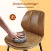 A hand is wiping a brown bar stool with a cloth, showing water droplets on the seat. Podgląd zdjęcia produktu