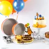 A birthday party setup with cakes, balloons, and baking tins. Produktbild-Vorschau