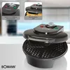 A black Bomann waffle maker is shown on a white surface with a blurred background. Two inset images highlight features of the waffle maker. Náhled obrázku produktu