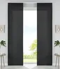Two dark gray panel curtains are drawn, partially obscuring a window with a view of trees and sky. Small decorative items and plants are visible on either side of the window. Produktbild-Vorschau