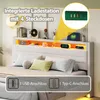 A bed with a headboard featuring integrated charging ports and decorative elements. Anteprima dell’immagine prodotto