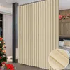 A room divider curtain is shown in a room with a Christmas tree and a bed. Náhled obrázku produktu