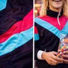 A split image showing a close-up of a tracksuit and a person wearing it while holding candy. Voir les images du produit