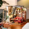 A miniature dollhouse living room scene with furniture, fireplace, and bookshelf. Náhľad obrázku produktu