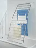 A drying rack for laundry is placed over a bathtub in a tiled bathroom. Anteprima dell’immagine prodotto
