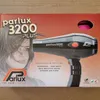The image shows the retail packaging of a Parlux 3200 Plus hair dryer. A drawing of a woman's face is on the left side of the box, and the hair dryer is depicted on the right. Náhled obrázku produktu