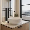 A modern bathroom sink with a black faucet. Anteprima dell’immagine prodotto