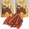 Two bags of dog treats with a pile of treats in front. Produktbild-Vorschau