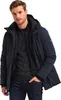 A man wearing a navy blue parka jacket and jeans, posing against a white background. Produktbild-Vorschau