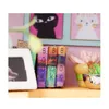 A close-up view of miniature books and decorative items on a shelf. Anteprima dell’immagine prodotto