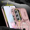 A close-up marketing image of a pink phone case with a sliding camera cover and a ring stand, highlighting raised bezels for screen and camera protection. Náhled obrázku produktu