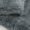 A close-up view of a fluffy, shaggy gray rug. Produktbild-Vorschau