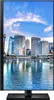 A vertical shot of a computer monitor displaying a cityscape with a waterfront and skyscrapers under a blue sky with clouds. Produktbild-Vorschau