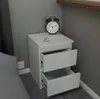 A white nightstand with two open drawers sits next to a bed. Anteprima dell’immagine prodotto