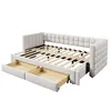 A beige upholstered daybed with its mattress support frame exposed and two storage drawers pulled out. Náhľad obrázku produktu