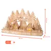 A wooden Christmas decoration depicting a village scene with trees and houses, illuminated by LEDs. Voir les images du produit