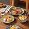 A table setting with plates, bowls, and food, suggesting a meal. Náhled obrázku produktu