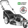 A GÜDE lawnmower is shown from a three-quarter front angle against a white background. The lawnmower is black and silver with large rear wheels and smaller front wheels. It has a pull-start engine and a grass collection bag. Produktbild-Vorschau